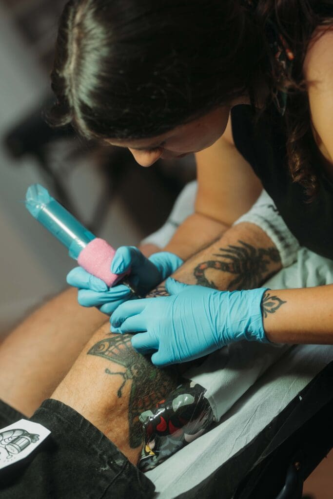 Oxfordshire Tattoo Artist, Hannah Simone, caught in action tattooing one of her quirky creations. Hannah Simone is based at Oxfordshire Tattoo Studio, Black Hound Tattoo.
